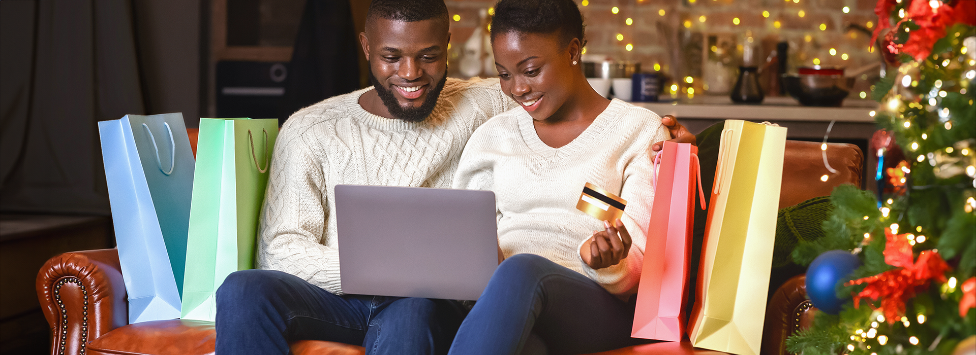 Couple shopping on a laptop happily while avoiding payment scams