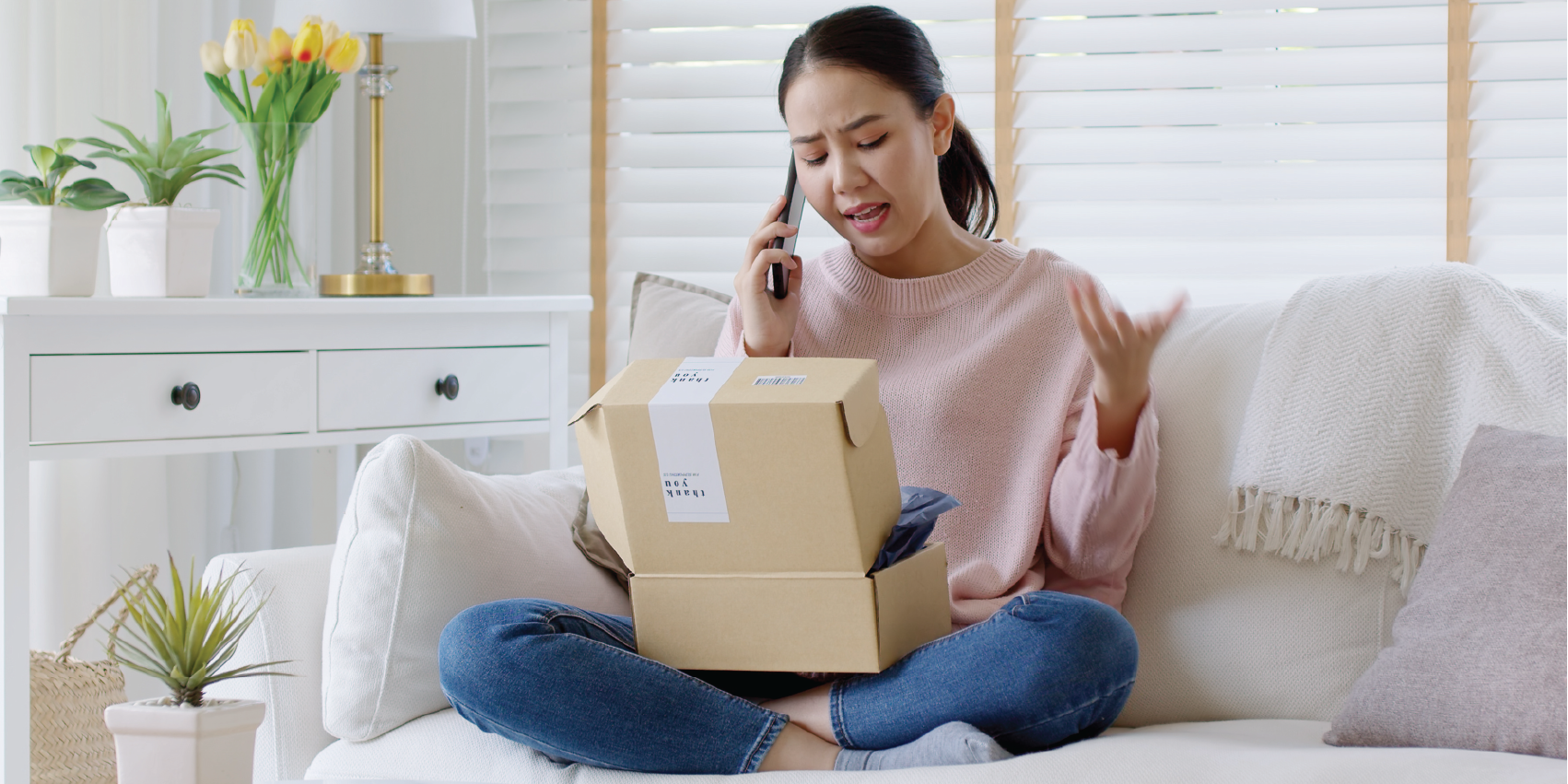 Woman on phone with box in front of her